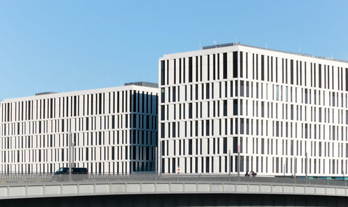 Low angle view of office building against blue sky