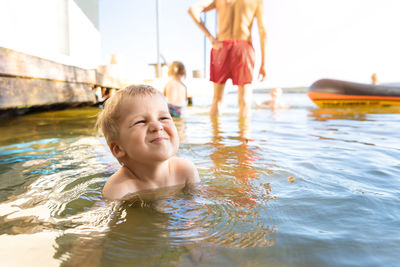 Close-up of boy playing in water outdoors