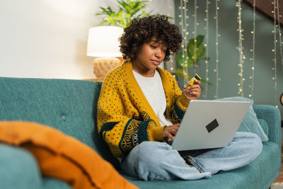 Young woman using laptop at home