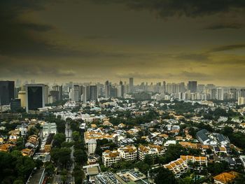 View of cityscape against cloudy sky