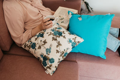 High angle view of woman sitting on sofa at home