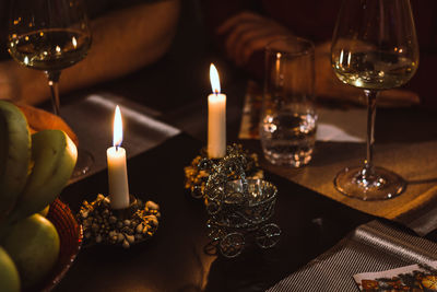 Close-up of illuminated tea light candles on table