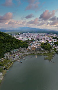 High angle view of townscape by sea against sky