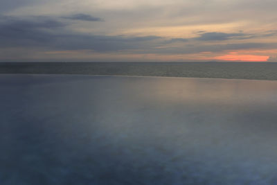 Scenic view of sea against sky at sunset