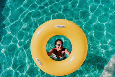 High angle portrait of smiling boy in swimming pool