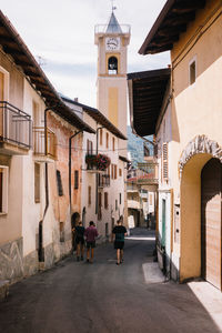 People walking amidst buildings in city