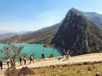 People on mountain road against sky