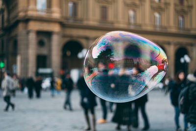 Close-up of bubble flying on street in city