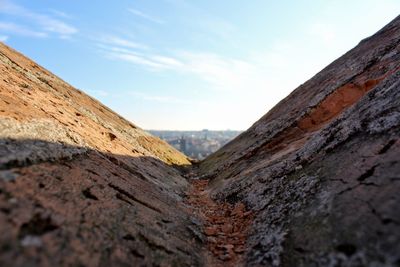 Close-up of rock against sky