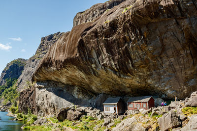 Rock formation amidst buildings against sky