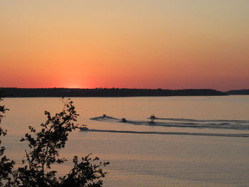 Scenic view of lake against orange sky