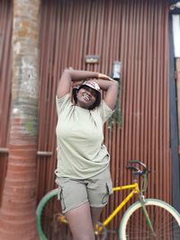 Portrait of smiling young woman with bicycle