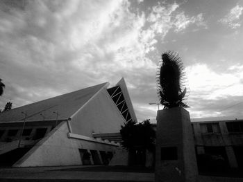 Low angle view of built structure against cloudy sky