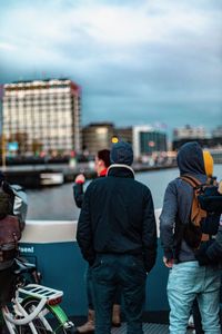 Rear view of people looking at city