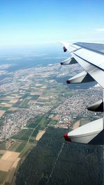 Cropped image of airplane wing over landscape