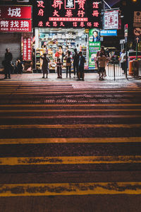 People walking on road in city at night