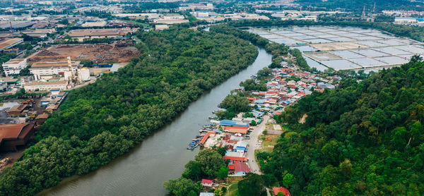 High angle view of townscape by river in city