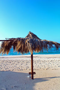 Built structure on beach against clear blue sky