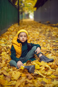Portrait of young woman sitting on field