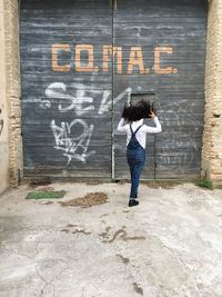 Full length of woman standing by railing