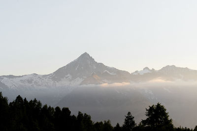 Scenic view of snowcapped mountains against clear sky