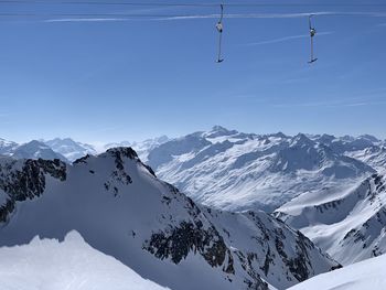 Scenic view of snow covered mountains against sky