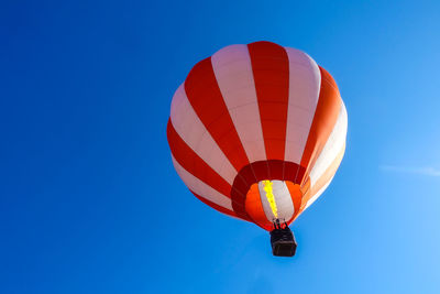 Low angle view of hot air balloon against blue sky