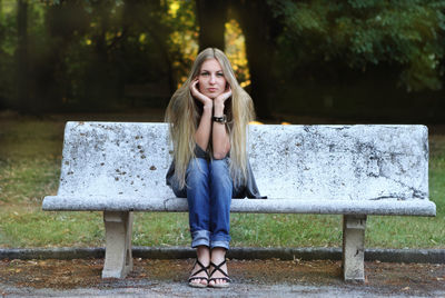 Portrait of smiling woman sitting on bench