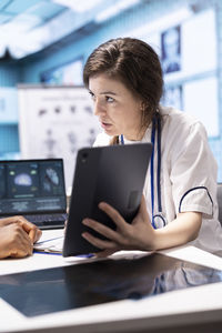 Businesswoman using laptop at table
