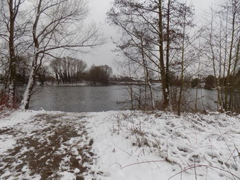 Scenic view of lake against sky during winter