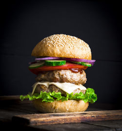 Close-up of burger against black background