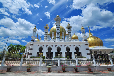 Low angle view of building against cloudy sky