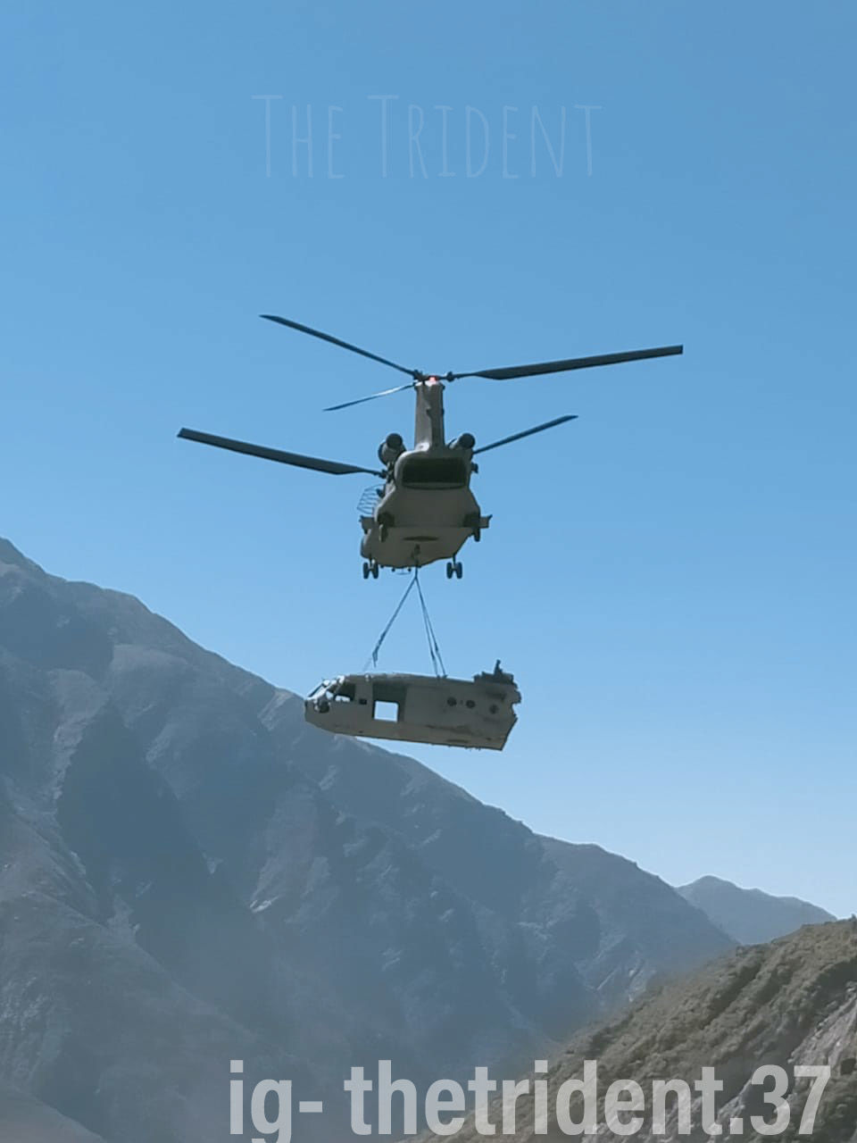 helicopter, air vehicle, transportation, mountain, flying, mode of transportation, aircraft, vehicle, sky, nature, airplane, communication, aviation, mid-air, military, rotorcraft, aerospace industry, blue, text, travel, sign, day, mountain range, no people, environment, military helicopter, government, outdoors, air force, clear sky