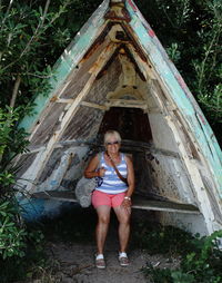 Portrait of woman smiling while sitting in abandoned boat