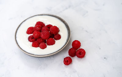 High angle view of strawberries in plate on table