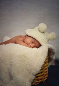 Cute baby sleeping on moses basket at home