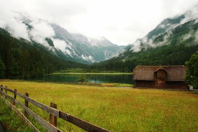 Scenic view of mountain range against cloudy sky