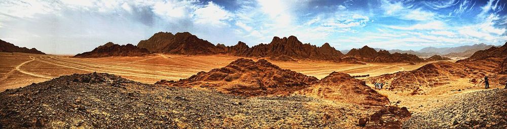 Scenic view of mountain against cloudy sky