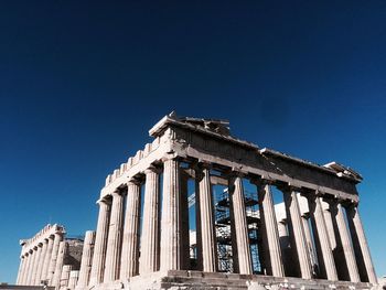 Low angle view of historical building against blue sky