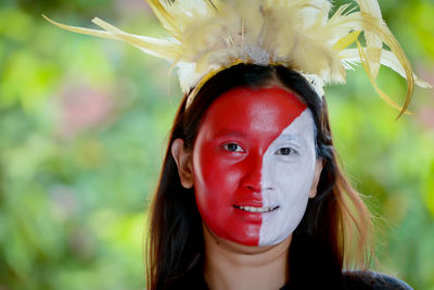 Portrait of woman with face paint standing outdoors