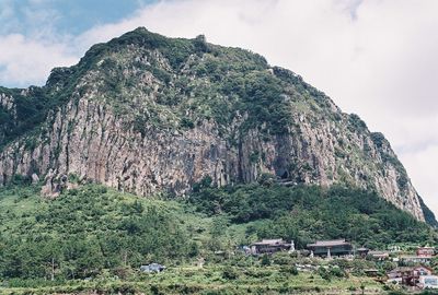 Scenic view of mountains against cloudy sky