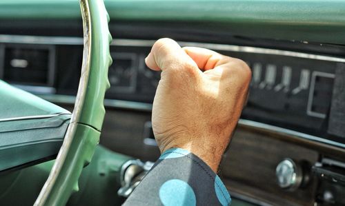 Midsection of man in car