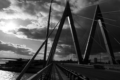 View of suspension bridge against cloudy sky