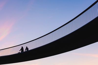 Low angle view of silhouette bridge against sky during sunset