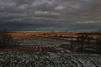 View of storm clouds over farm
