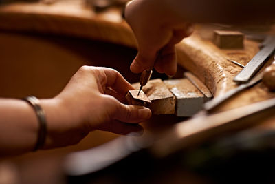 Cropped hand of man working at workshop