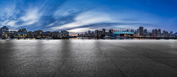 View of buildings in city against cloudy sky