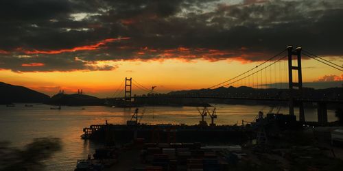 Silhouette of suspension bridge at sunset