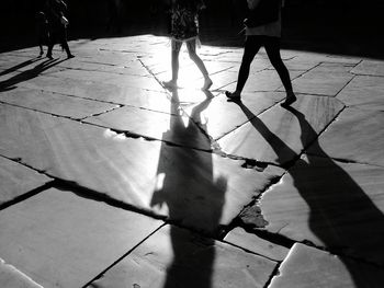 Shadow of people on footpath