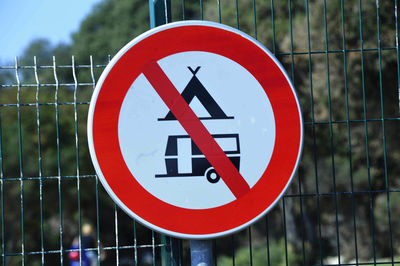 Close-up of warning sign on fence